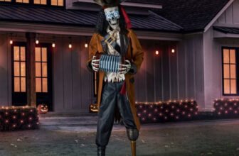Member's Mark 7 ft animated pirate skeleton with glowing LED eyes playing an accordion on a front lawn at dusk