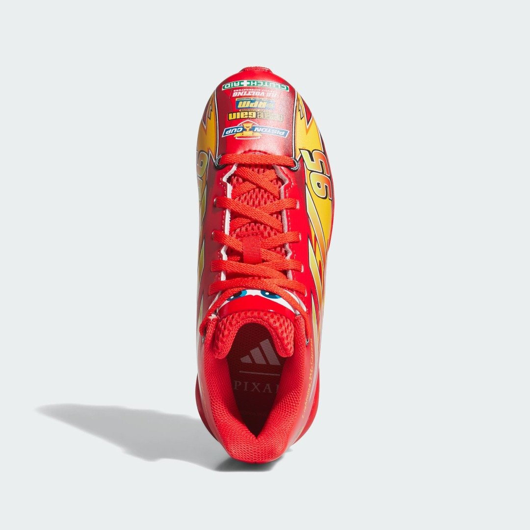 Top-down view of the adidas Pixar Cars kids cleat showing Lightning McQueen's eyes on the tongue and race decals