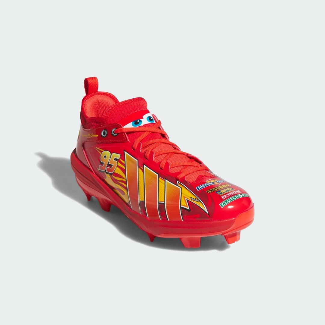 Angled front view of the adidas Pixar Cars Adizero Impact 3.0 TPU cleat showing Lightning McQueen's eyes on the tongue