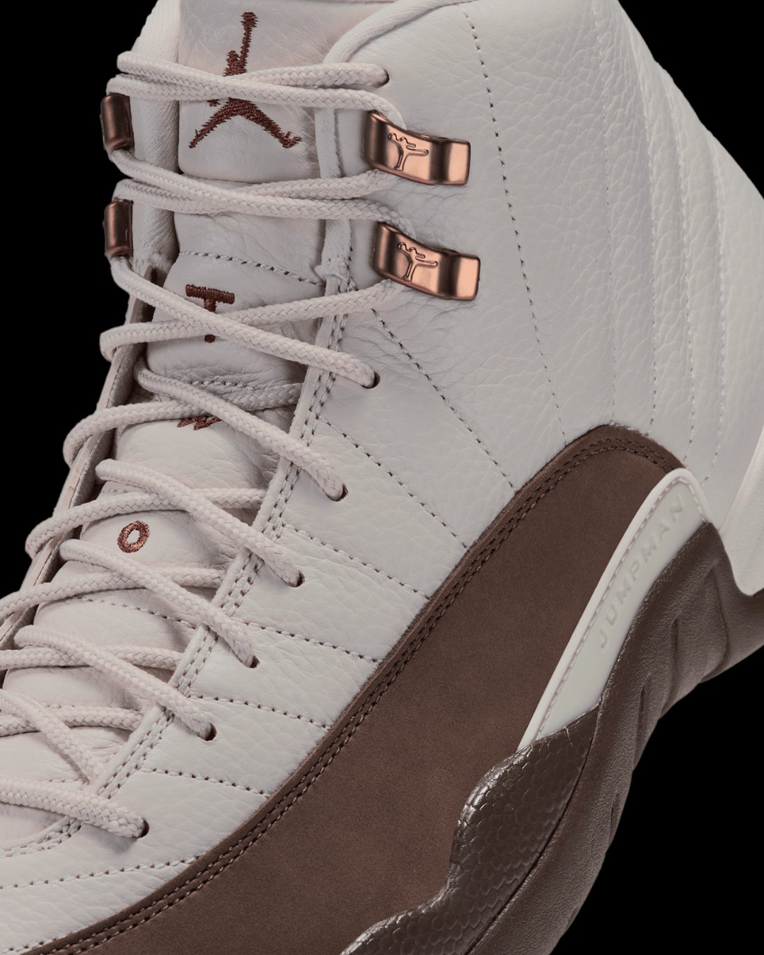 Close-up of Air Jordan 12 Fireside laces, copper Jumpman eyelets, and tumbled leather