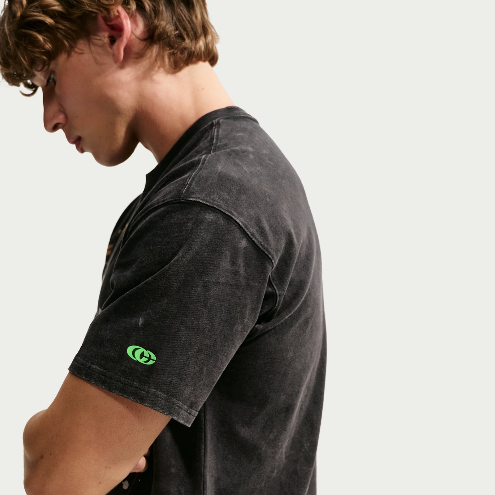 Sleeve detail on the Caitlin Clark Halloween tee with green CC logo