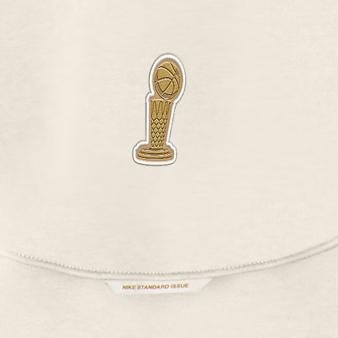 Gold trophy patch on the cream Knicks Nike champions hoodie