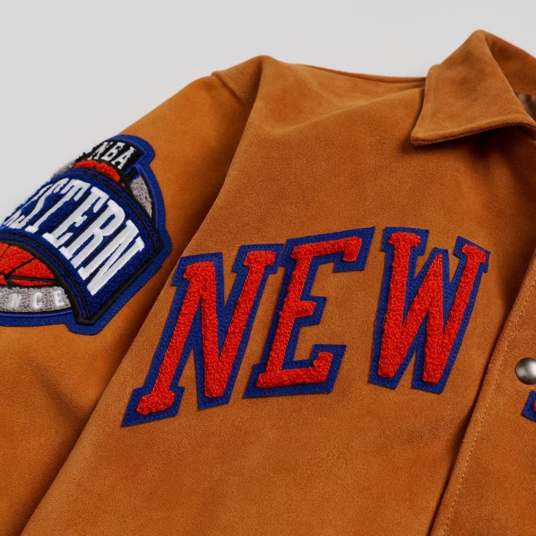Close-up of the chenille NEW lettering and Eastern Conference patch on the Knicks Artisan jacket