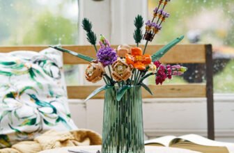 LEGO Botanicals Flower Bouquet 10280 in a glass vase by a rainy window