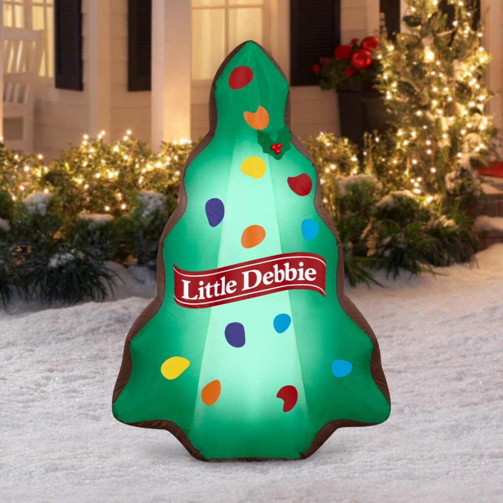 Little Debbie Green Christmas Tree Brownie 4.5 ft inflatable lit up in a snowy front yard