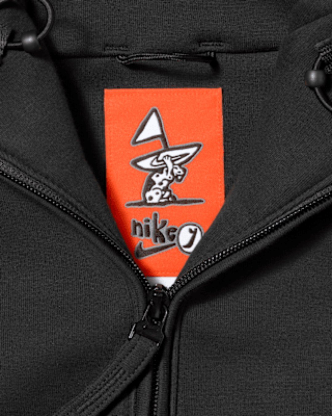 Custom orange Lil Yachty label inside the Nike Tech fleece jacket