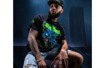 Model wearing the Outkast x Atlanta Falcons ATLiens album cover tee