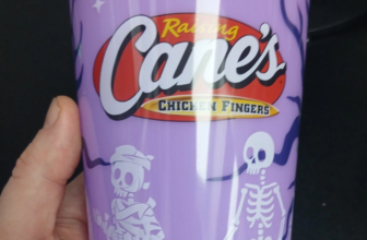 Raising Cane's purple glow-in-the-dark Halloween cup with skeletons and a mummy