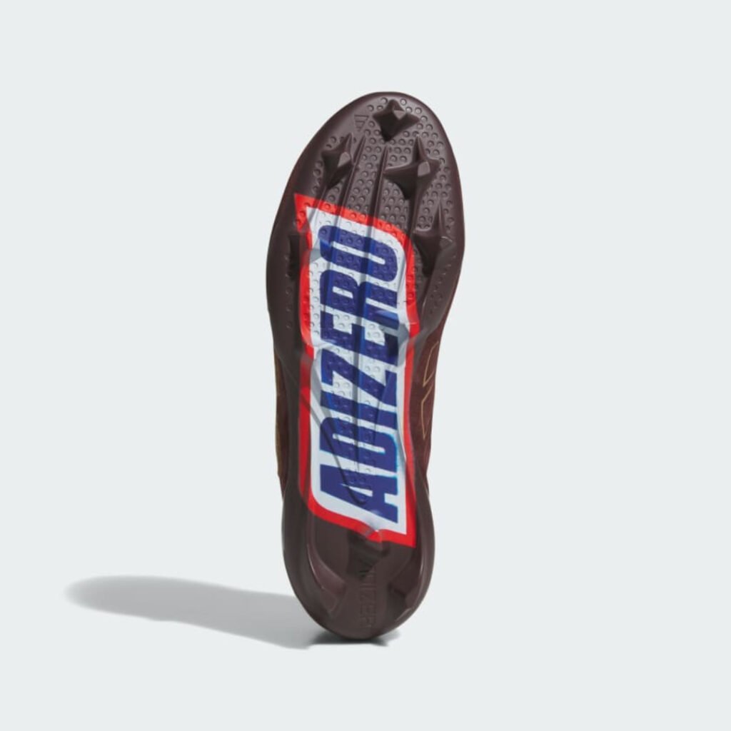 Outsole of the Snickers x adidas cleat printed with the Snickers wrapper style Adizero logo